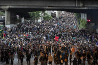 Pro-democracy protesters march during a protest in Udom Suk, suburbs of Bangkok, Thailand, Saturday, Oct. 17, 2020. The authorities in Bangkok shut down mass transit systems and set up roadblocks Saturday as Thailand’s capital faced a fourth straight day of determined anti-government protests. (AP Photo/Gemunu Amarasinghe)