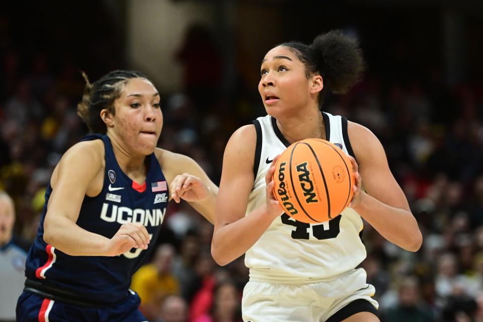 Iowa forward Hannah Stuelke (45) dribbles the ball against Connecticut in Friday's national semifinal game.