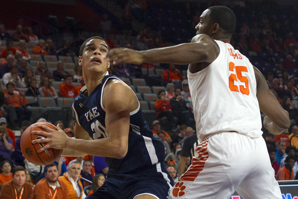 Dec 22, 2019; Clemson, South Carolina, USA; Yale Bulldogs forward Paul Atkinson (20) drives to the basket while being defended by Clemson Tigers forward Aamir Simms (25) during the first half of the game at Littlejohn Coliseum. 