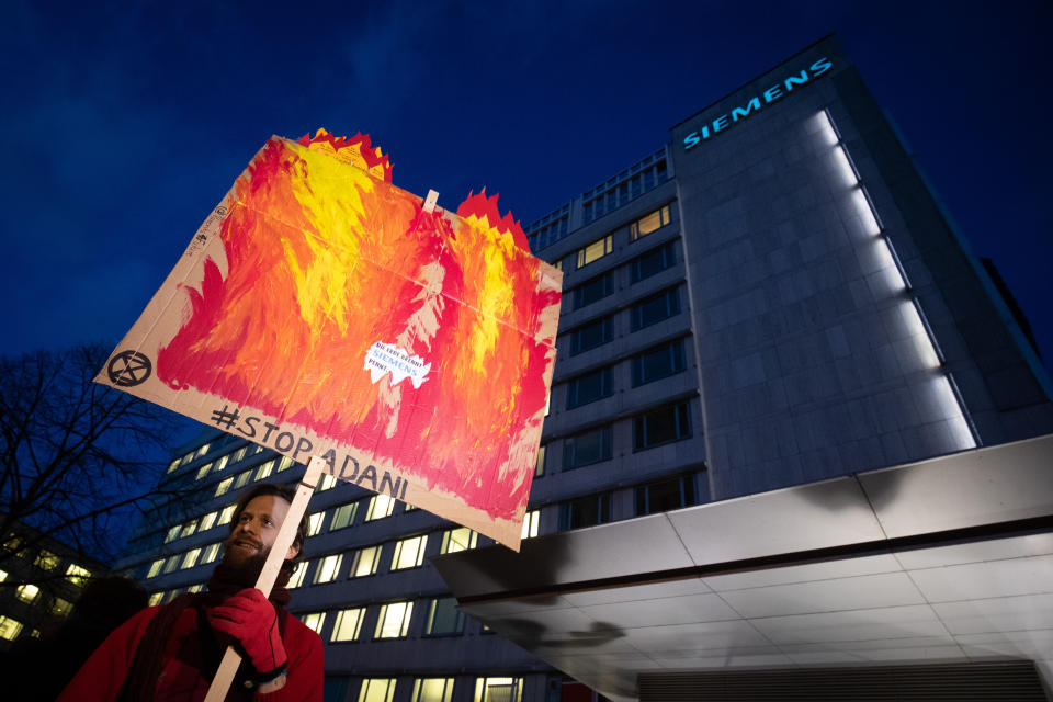 13 January 2020, Hamburg: Climate activists demonstrate during a Fridays for Future protest action in front of the Siemens office in Hamburg. The sign says "# Stop Adani". In response to the Siemens decision to supply technology for a controversial coal mine project in Australia, the demonstrators had agreed to rallies at various locations in Germany. Despite all criticism, the Munich-based industrial concern wants to stick with an order for a giant coal mine. Photo: Christian Charisius/dpa (Photo by Christian Charisius/picture alliance via Getty Images)