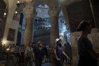 Tourists visit the Church of the Holy Sepulchre in Old City in Jerusalem, Wednesday, June 15, 2022. The summer of 2022 can feel as if the coronavirus pandemic is really over — mask rules and testing requirements are lifting in many countries, including the United States. But early in what was supposed to be a season of exuberance, there's evidence that economic recovery in the tourism industry is slower than hoped for. (AP Photo/Maya Alleruzzo)