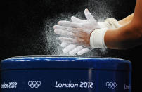 LONDON, ENGLAND - JULY 31: Silvana Saldarriaga of Peru chalks her hands prior to competing in the Women's 63kg Weightlifting final on Day 4 of the London 2012 Olympic Games at ExCeL on July 31, 2012 in London, England. (Photo by Laurence Griffiths/Getty Images)