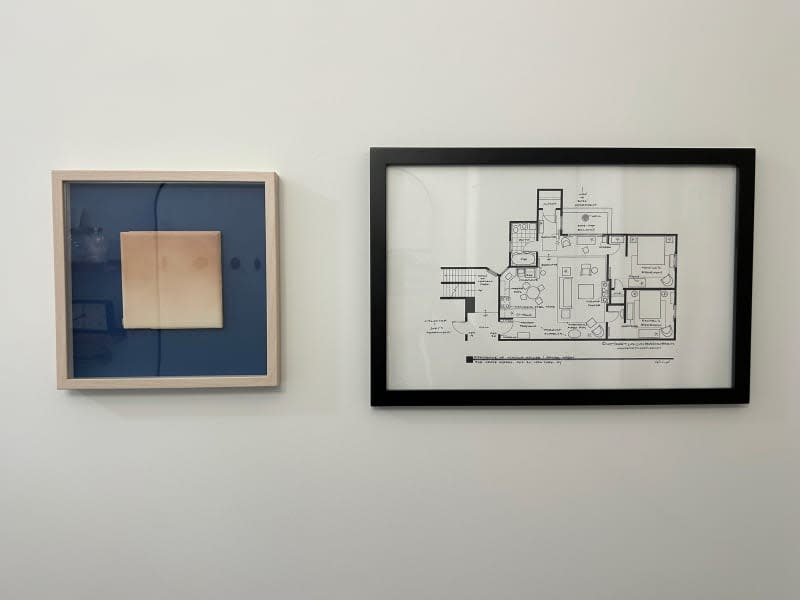 Framed floor plan on wall.