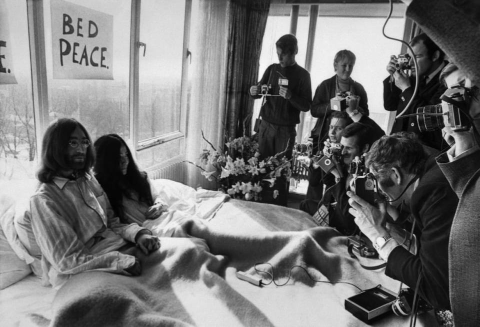 <div class="inline-image__caption"><p>John Lennon and his wife Yoko Ono receive journalists on March 25, 1969, in the bedroom of the Hilton hotel in Amsterdam, during their honeymoon in Europe.</p></div> <div class="inline-image__credit">AFP via Getty Images</div>