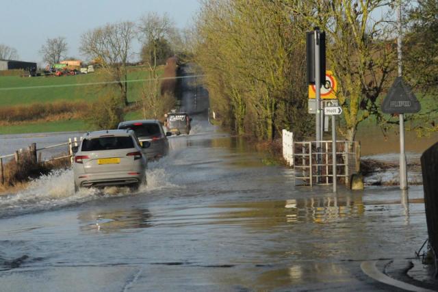 Drivers ignore road closed signs as flood warnings remain in place