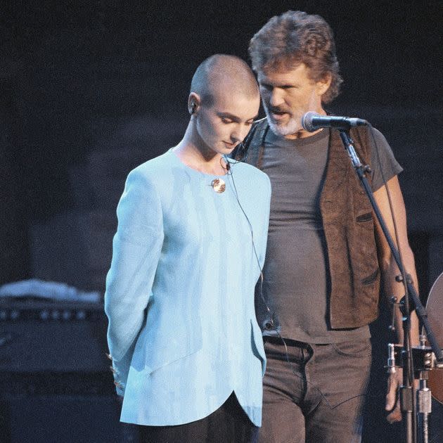 Singer Kris Kristofferson comforts O'Connor after she was booed offstage during a Bob Dylan anniversary concert at New York Madison Square Garden in 1992. The performance was O'Connor's first live event since she ripped a picture of Pope John Paul II during a performance on 
