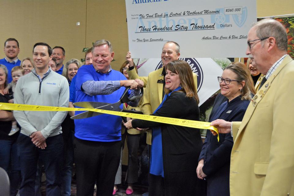 Anthem Blue Cross and Blue Shield Director of Sales John Van Wart and Food Bank for Central and Northeast Missouri President and CEO Lindsay Lopez, holding the scissors, prepare to cut the ribbon Thursday on a $360,000 partnership of the two organizations. 