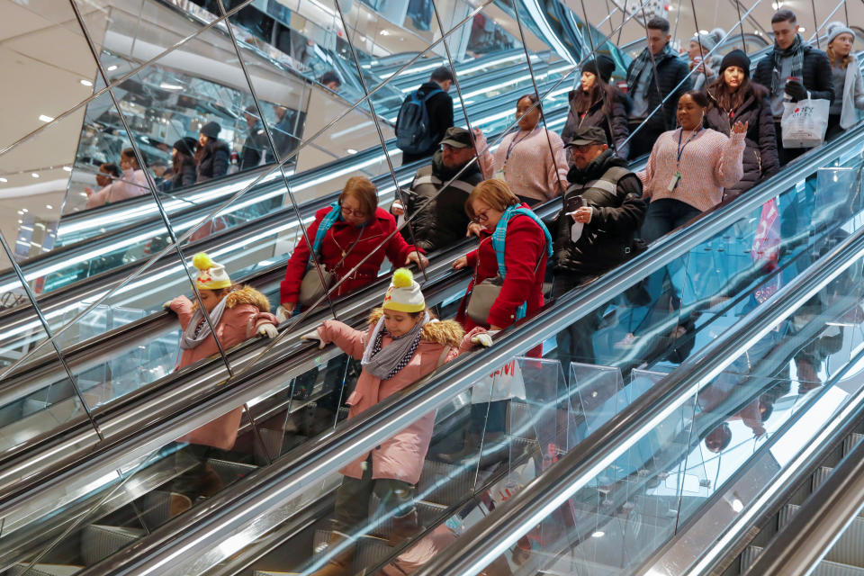 People ride an escalator in H & M during a Black Friday sales event in Manhattan, New York City, U.S., November 23, 2018. REUTERS/Andrew Kelly