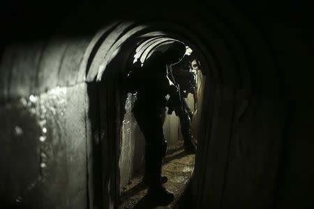 Palestinian fighters from the Izz el-Deen al-Qassam Brigades, the armed wing of the Hamas movement, are seen inside an underground tunnel in Gaza August 18, 2014. REUTERS/Mohammed Salem