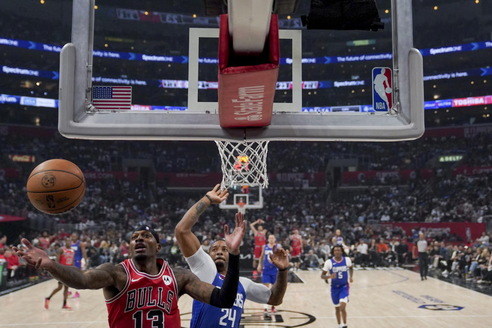 Chicago Bulls forward Torrey Craig (13) and Los Angeles Clippers guard Norman Powell (24) fight for the ball during the first half of an NBA basketball game in Los Angeles, Saturday, March 9, 2024. (AP Photo/Eric Thayer)