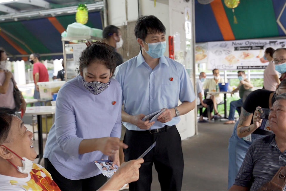 Raeesah Begum (left) and Jamus Lim, Workers’ Party candidates for Sengkang GRC, seen on walkabout in Anchorvale Link on 2 July 2020. (PHOTO: Yahoo News Singapore)