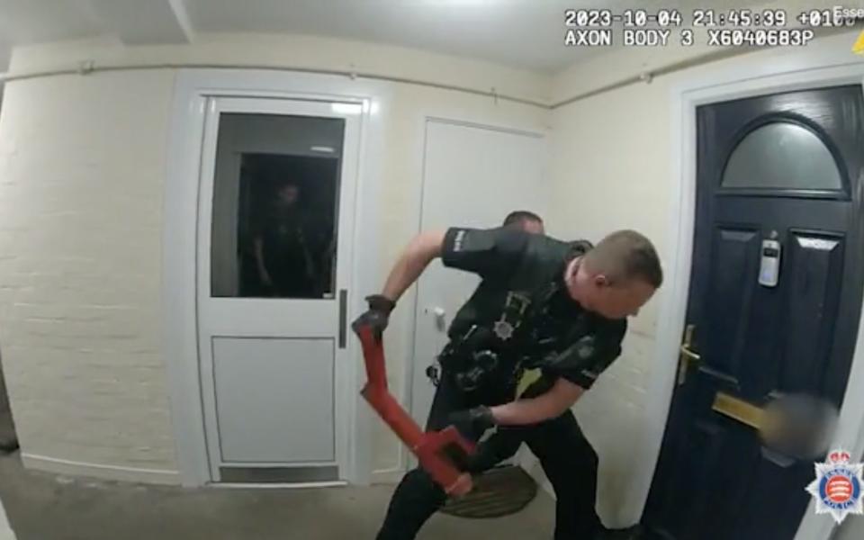 Police use a battering ram