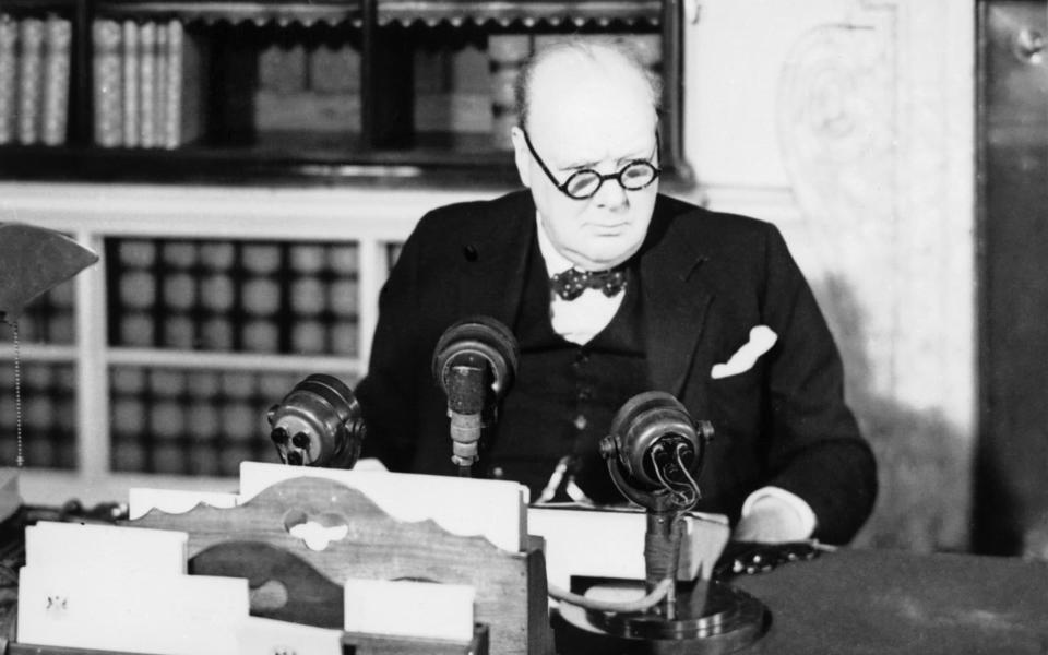 Winston Churchill at a BBC microphone about to make his VE Day broadcast - IWM/Getty Images