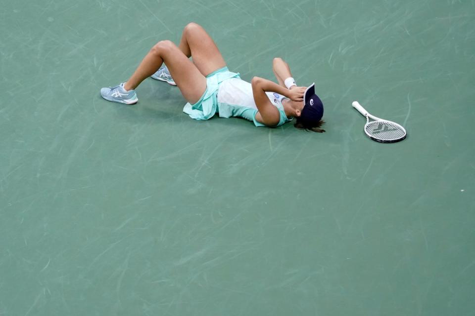 Iga Swiatek lies on the court after winning the title (Mary Altaffer/AP) (AP)