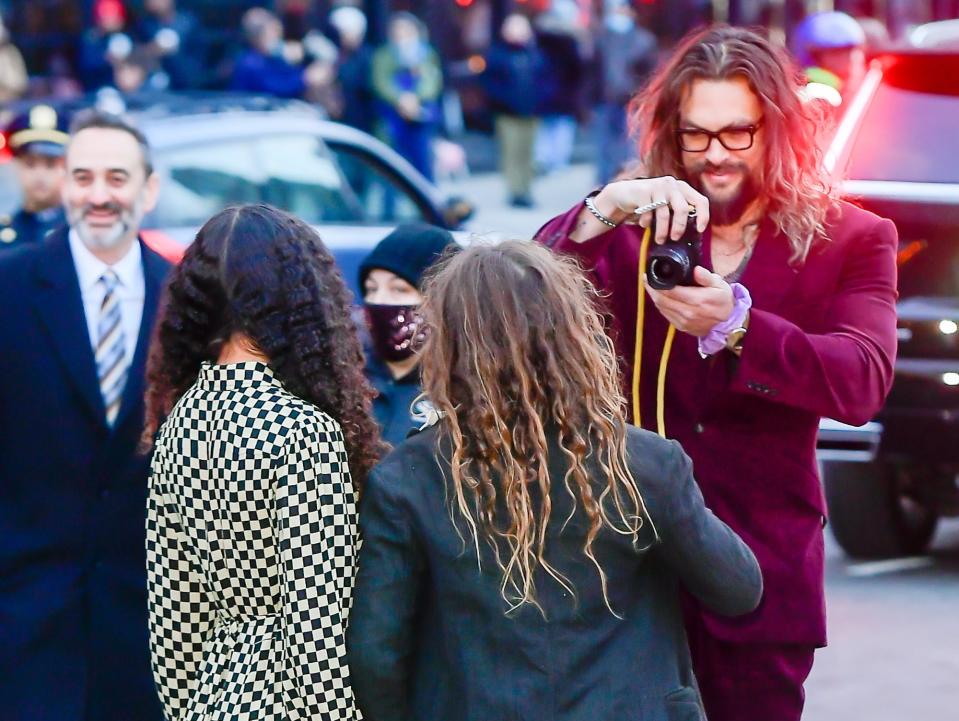 jason momoa taking a photo of his children lola and nakoa-wolf at the batman premiere in new york city