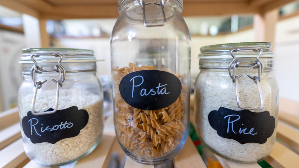A close up photograph of pasta in jars