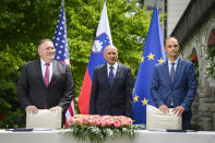 US Secretary of State Mike Pompeo, left, Slovenia's Prime Minister Janez Jansa, center, and Slovenia's Foreign Minister Anze Logar pose for the media after signing an agreement on fifth-generation internet technology in Bled, Slovenia, Thursday, Aug. 13, 2020. Pompeo is on a five-day visit to central Europe with a hefty agenda including China's role in 5G network construction. (Jure Makovec/Pool Photo via AP)