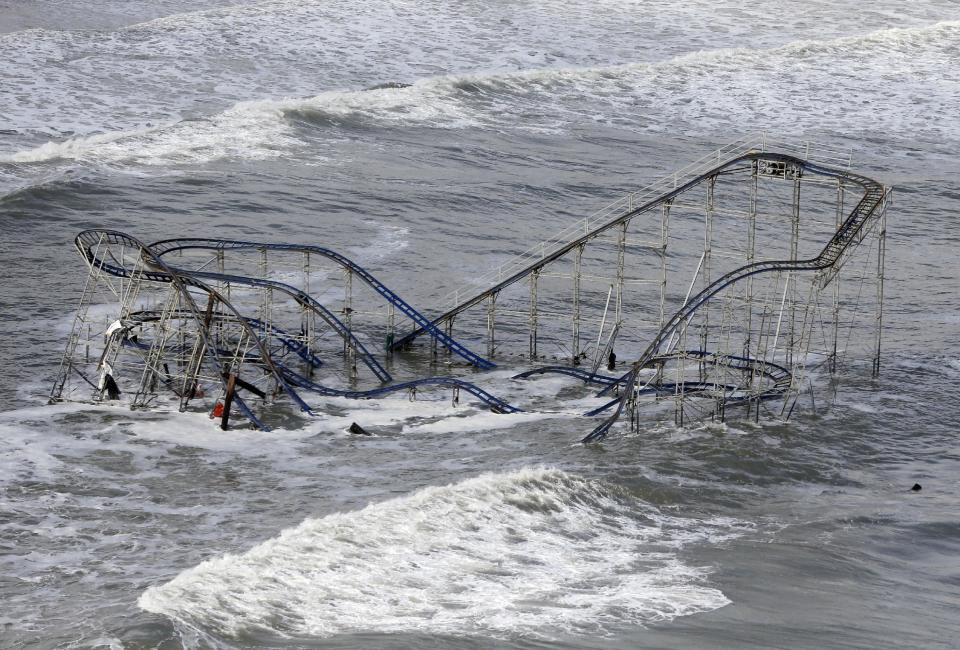 FILE - In this Wednesday, Oct. 31, 2012 file photo, waves wash over a roller coaster from a Seaside Heights, N.J., amusement park that fell in the Atlantic Ocean during Superstorm Sandy. (AP Photo/Mike Groll, File)