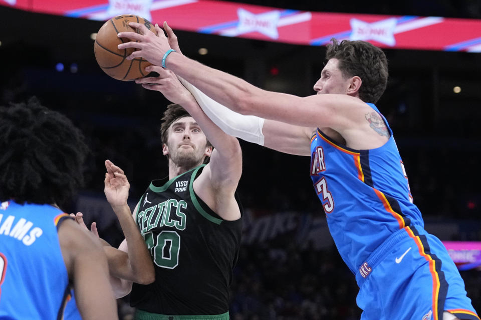 =t[bc40n= and Oklahoma City Thunder center Mike Muscala, right, reach for the ball in the first half of an NBA basketball game Tuesday, Jan. 3, 2023, in Oklahoma City. (AP Photo/Sue Ogrocki)