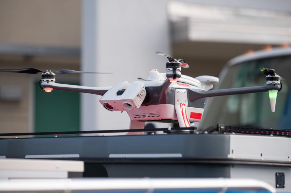 A Florida Power & Light drone, made by Percepto and capable of autonomous flight, sits on its "drone in a box" flight pad. the utility says the "drone in a box" program can be used to survey storm damage from the skies autonomously.