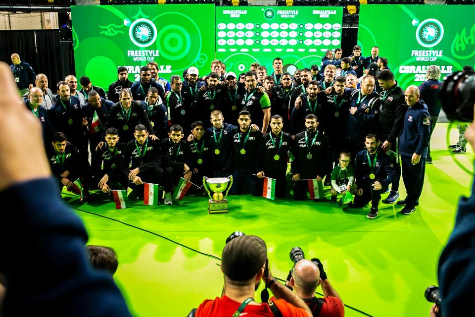 Members of the United States and Iran wrestling teams pose for a photo together during championship finals of the United World Wrestling men's freestyle World Cup on Sunday.