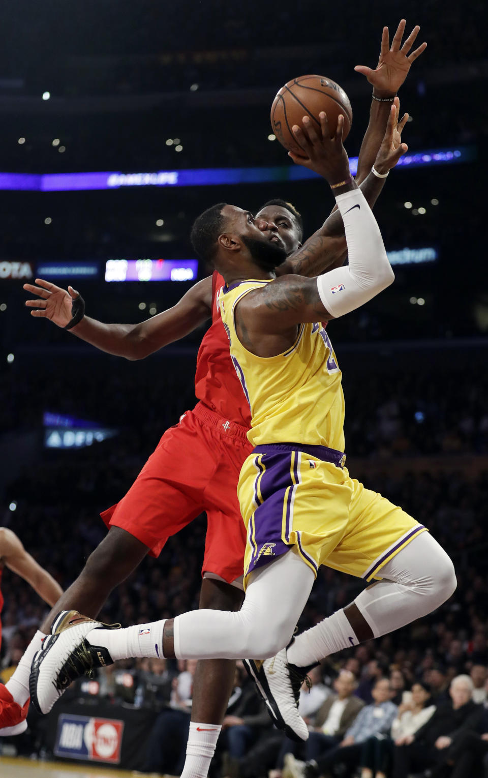 Los Angeles Lakers' LeBron James, front, drives to the basket as Houston Rockets' Clint Capela defends during the first half of an NBA basketball game Thursday, Feb. 21, 2019, in Los Angeles. (AP Photo/Marcio Jose Sanchez)