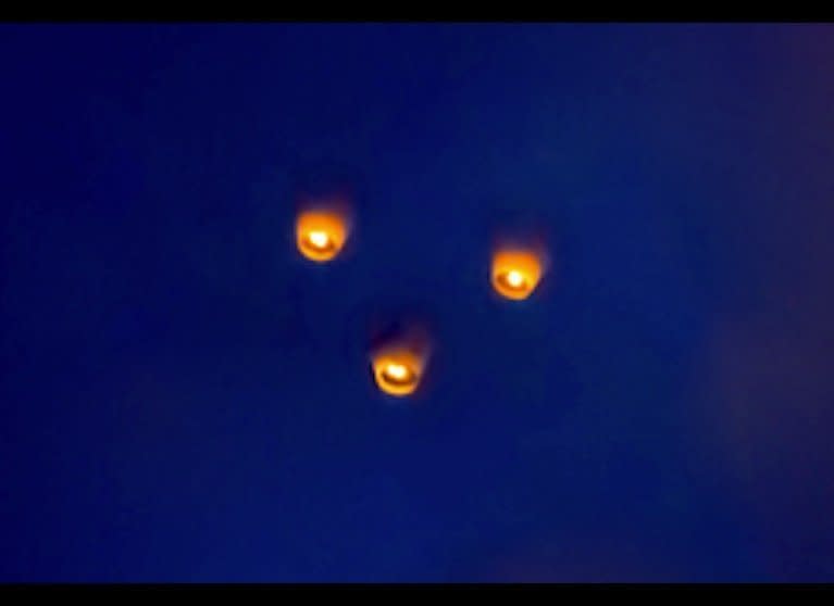 Chinese or sky lanterns are often misidentified as UFOs. These three were part of a large group of lanterns that was the main event of the 2013 Pingxi Sky Lantern Festival in Taiwan on Feb. 24, 2013.