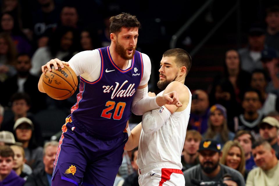 Jusuf Nurkic (20), center of the Phoenix Suns, advances to the basket against Ivica Zubac (40), center of the LA Clippers, in the first quarter at the Footprint Center in Phoenix on January 3, 2024.