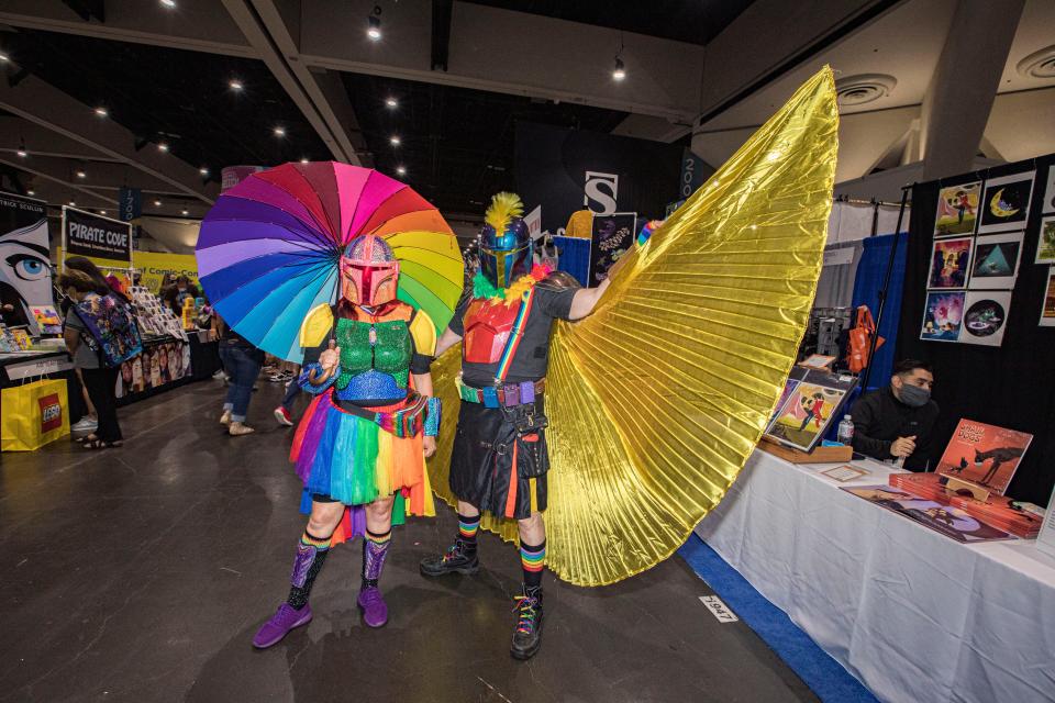 Star Wars cosplayers Lisa Lower as Sparkle Fett (L) and Shawn Richter as Pride Mando pose for photos at 2022 Comic-Con International Day 2 at San Diego Convention Center on July 22, 2022 in San Diego, California. (Photo by