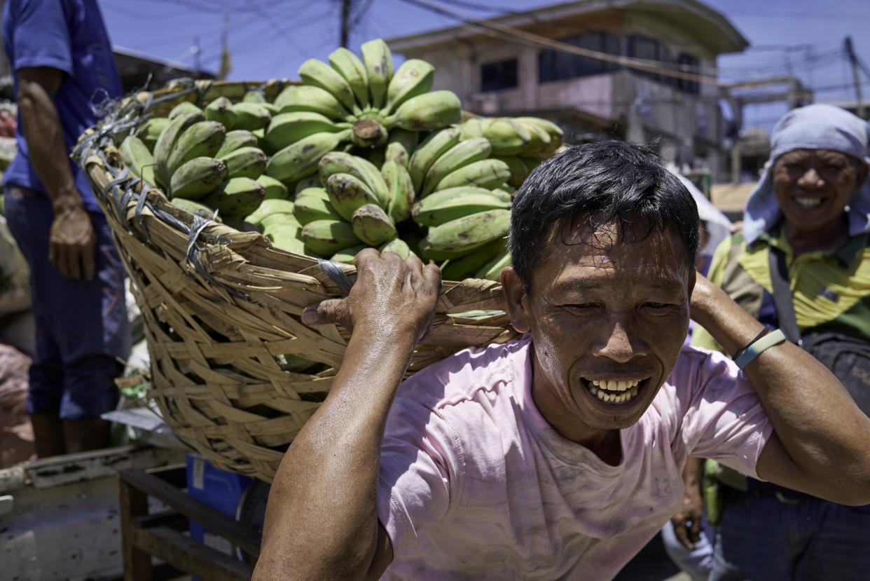 CARBON MARKET, CEBU, CENTRAL VISAYAS, PHILIPPINES - 2019/04/25: Close portrait of a porter carrying a heavy basket of bananas. (Photo by Jorge Fernández/LightRocket via Getty Images)