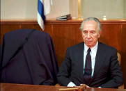<p>Israeli acting Prime Minister Shimon Peres, sits beside the empty chair of Prime Minister Yitzhak Rabin during a cabinet meeting in Jerusalem on Nov. 5, 1995. Rabin was shot dead late by a right wing extremist in Tel Aviv. (STR New/Reuters) </p>