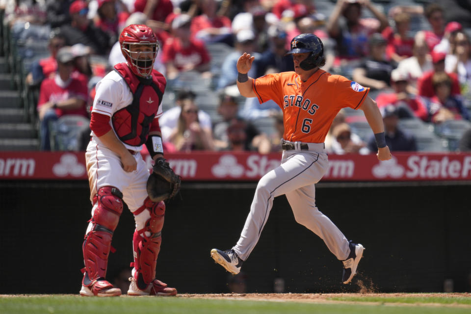 Houston Astros' Jake Meyers (6) scores off of a single by Jeremy Pena during the fourth inning of a baseball game in Anaheim, Calif., Wednesday, May 10, 2023. David Hensley also scored. (AP Photo/Ashley Landis)