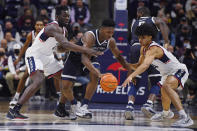 Connecticut's Adama Sanogo, left, and Connecticut's Andre Jackson, right, pressure Georgetown's Aminu Mohammed in the first half of an NCAA college basketball game, Tuesday, Jan. 25, 2022, in Storrs, Conn. (AP Photo/Jessica Hill)