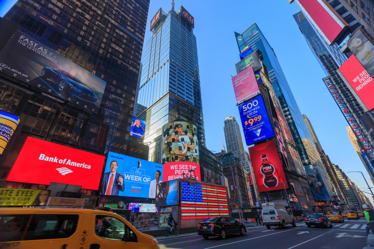 New York, USA - May 8, 2018 : The architecture of New York city in the USA at Times Square with its neon signs, stores, chaotic traffic, and tons of tourists and locals passing by.