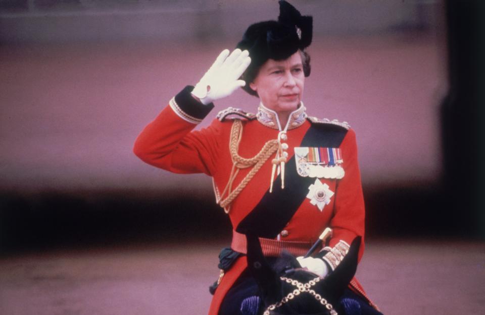Queen Elizabeth II in military uniform, saluting on horseback