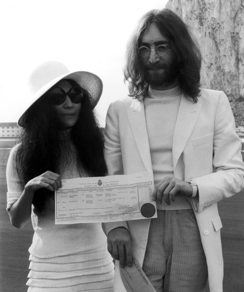 John Lennon and Yoko Ono hold their marriage certificate after their marriage in Gibraltar.