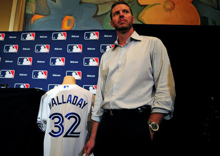 FILE PHOTO: Former pitcher Roy Halladay waits before announcing his retirement the MLB Winter Meetings at Walt Disney World Swan and Dolphin Resort in Orlando, Florida, U.S., December 9, 2013. Mandatory Credit: David Manning-USA TODAY Sports/File Photo