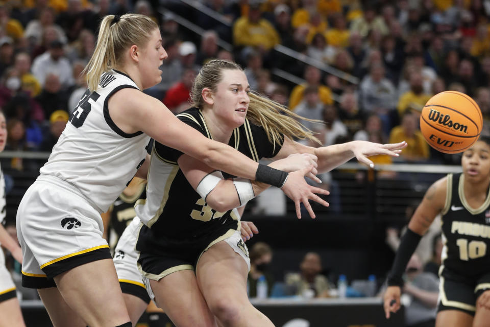 Purdue forward Caitlyn Harper passes the ball away from Iowa forward Monika Czinano (25) during the first half of an NCAA college basketball game at the Big Ten women's tournament Friday, March 3, 2023, in Minneapolis. (AP Photo/Bruce Kluckhohn)