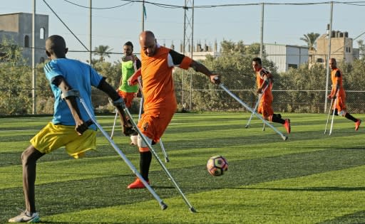 Palestinian amputee soccer players train in Deir El-Balah in the central Gaza Strip on July 9, 2018