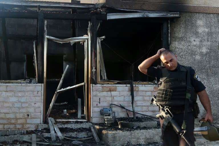 Israeli security forces inspect the Palestinian house that was set on fire in the West Bank village of Duma, on July 31, 2015