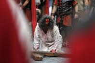 An actor takes part in a re-enactment of the "Via Crucis" (Way of the Cross), which commemorates the crucifixion of Jesus Christ, during the Orthodox Holy Week celebrations in Bucharest April 15, 2014. Romania's Christian Orthodox majority will celebrate Easter on April 20 together with Catholic believers. REUTERS/Bogdan Cristel (ROMANIA - Tags: RELIGION SOCIETY)