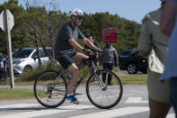 President Joe Biden pedals his bike towards a crowd at Gordons Pond in Rehoboth Beach, Del., Saturday, June 18, 2022. Biden fell from his bike as he tried to get off it to greet the crowd. (AP Photo/Manuel Balce Ceneta)