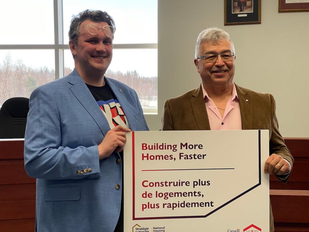 Yellowknife deputy mayor Garett Cochrane, left, with N.W.T. MP Michael McLeod on Monday, announcing new funding aimed at fast-tracking housing development in the city.  (Robert Holden / CBC - image credit)