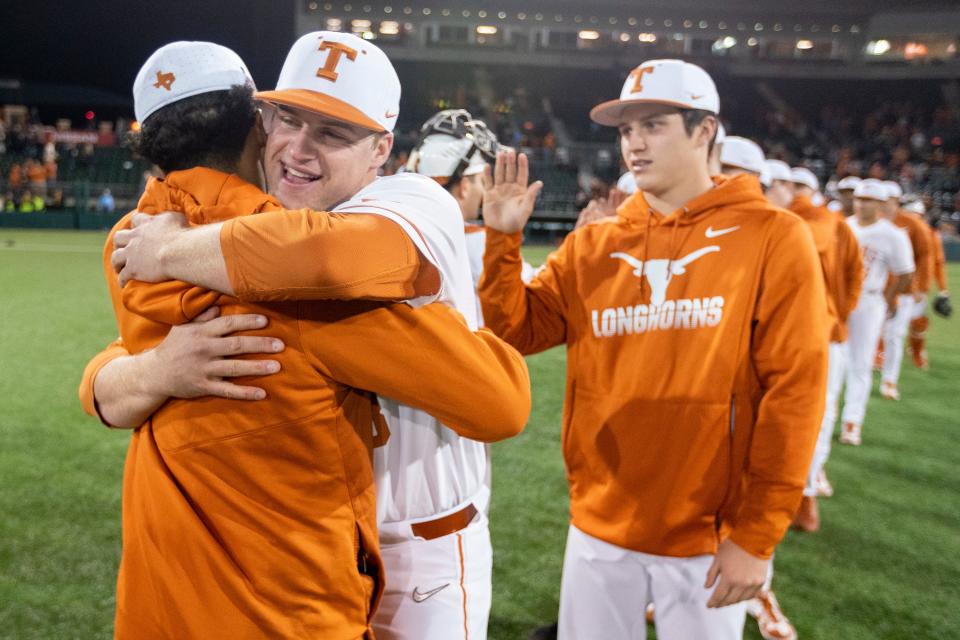 Texas pitcher Bryce Elder, middle, hugs Cam Constantine as they celebrate a 6-1 win over Cal State Fullerton during in Austin in March of 2020.