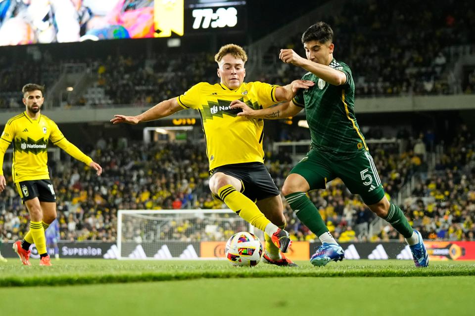 Crew midfielder Aidan Morris fights for the ball with Timbers defender Claudio Bravo on April 20.