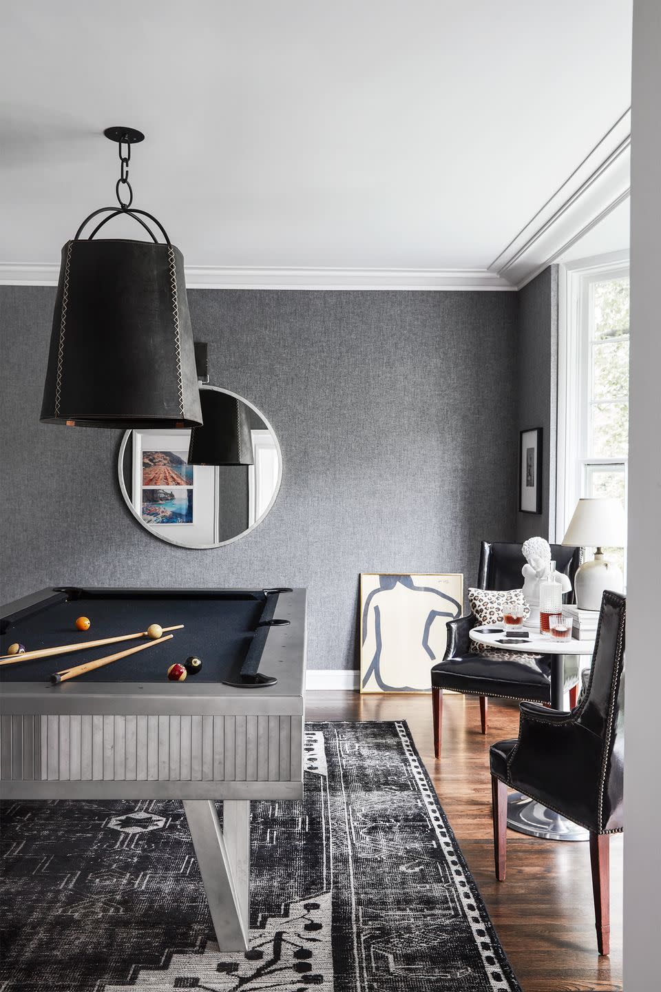 <p>This sleek monochromatic game room in the home of CB2 president Ryan Turf and his wife, Jessica, of Turf Design, pulls out all the stops. Though the main attraction is the pool table, the pedestal table and sitting area on the periphery make this the perfect place for a night cap, too. </p>