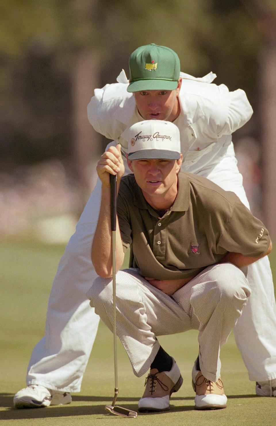 Davis Love III looks over a putt at the 10th hole of the Augusta National Golf Club with his brother and caddie Mark Love during the final round in the 1995 Masters Tournament.