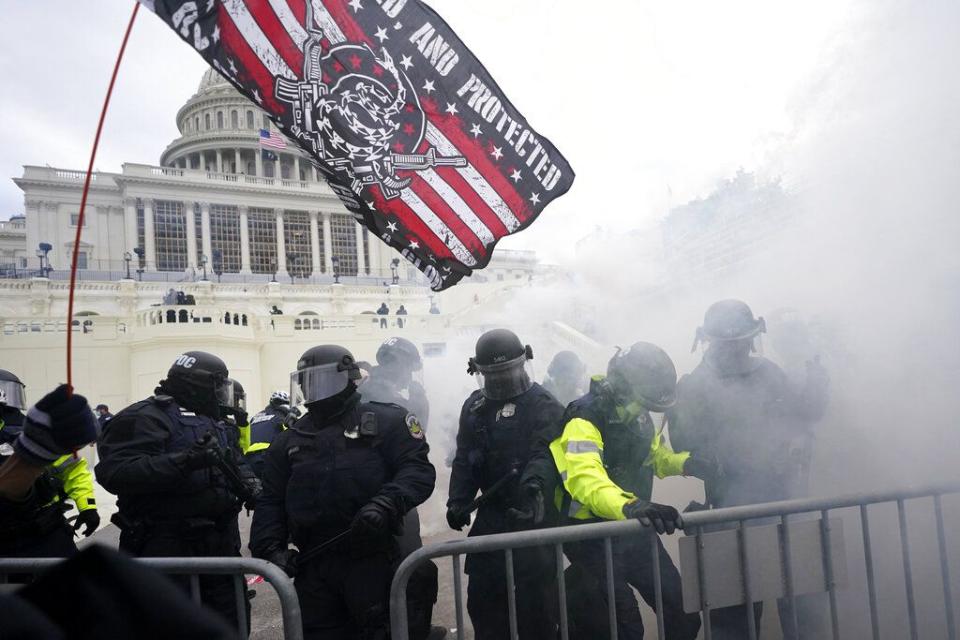 Police hold off Trump supporters who tried to break through a police barrier, Wednesday, Jan. 6, 2021, at the Capitol in Washington. As Congress prepares to affirm President-elect Joe Biden's victory, thousands of people have gathered to show their support for President Donald Trump and his claims of election fraud. (AP Photo/Julio Cortez)