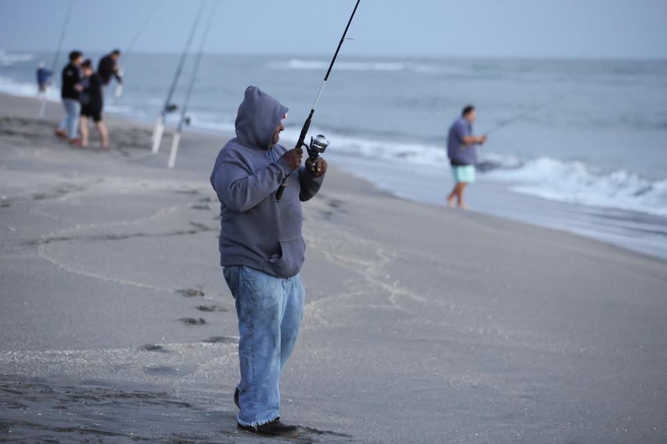 Fishermen are seen at Hobe Sound Beach on Saturday, Dec. 30, 2023. The National Weather Service office in Melbourne gave the region's daytime forecast as partly sunny and cool, with temperatures "as much as 10 degrees below normal."