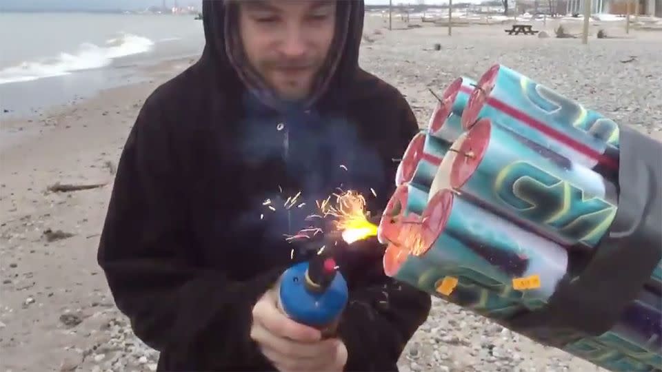 One man lit the contraption while another held on to it. Photo: Youtube/aspahn2009